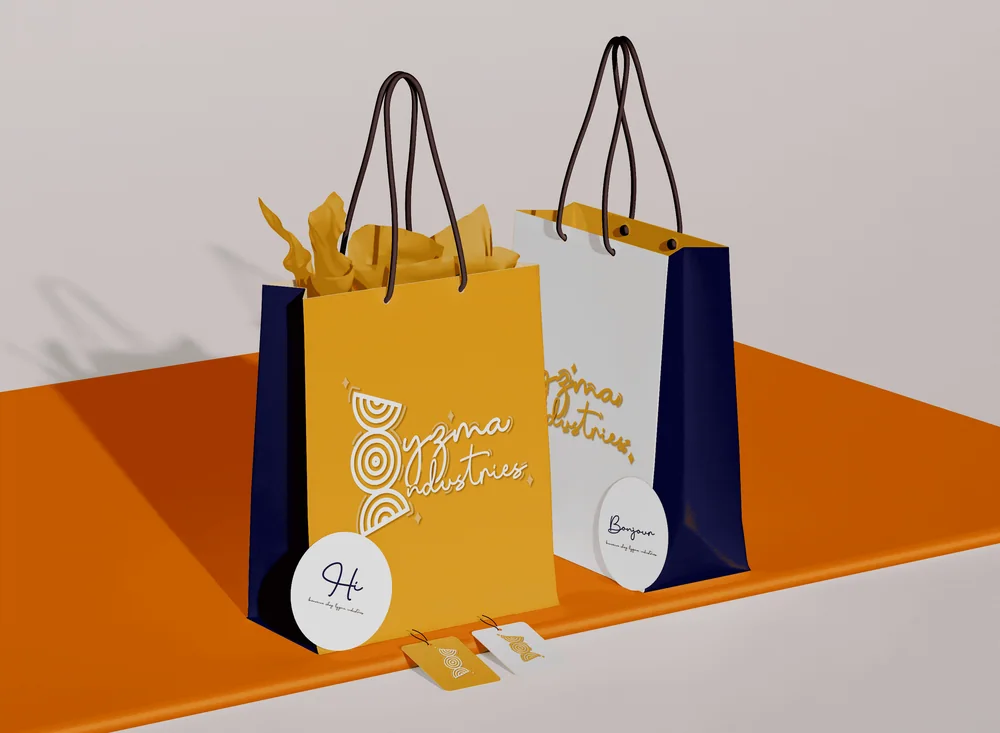 Lyzma Industries branded shopping bags in gold, white and navy